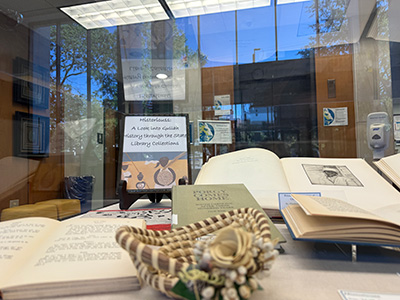 Open books and images in our display case from the South Carolina, Salley, and Rare Books collections.