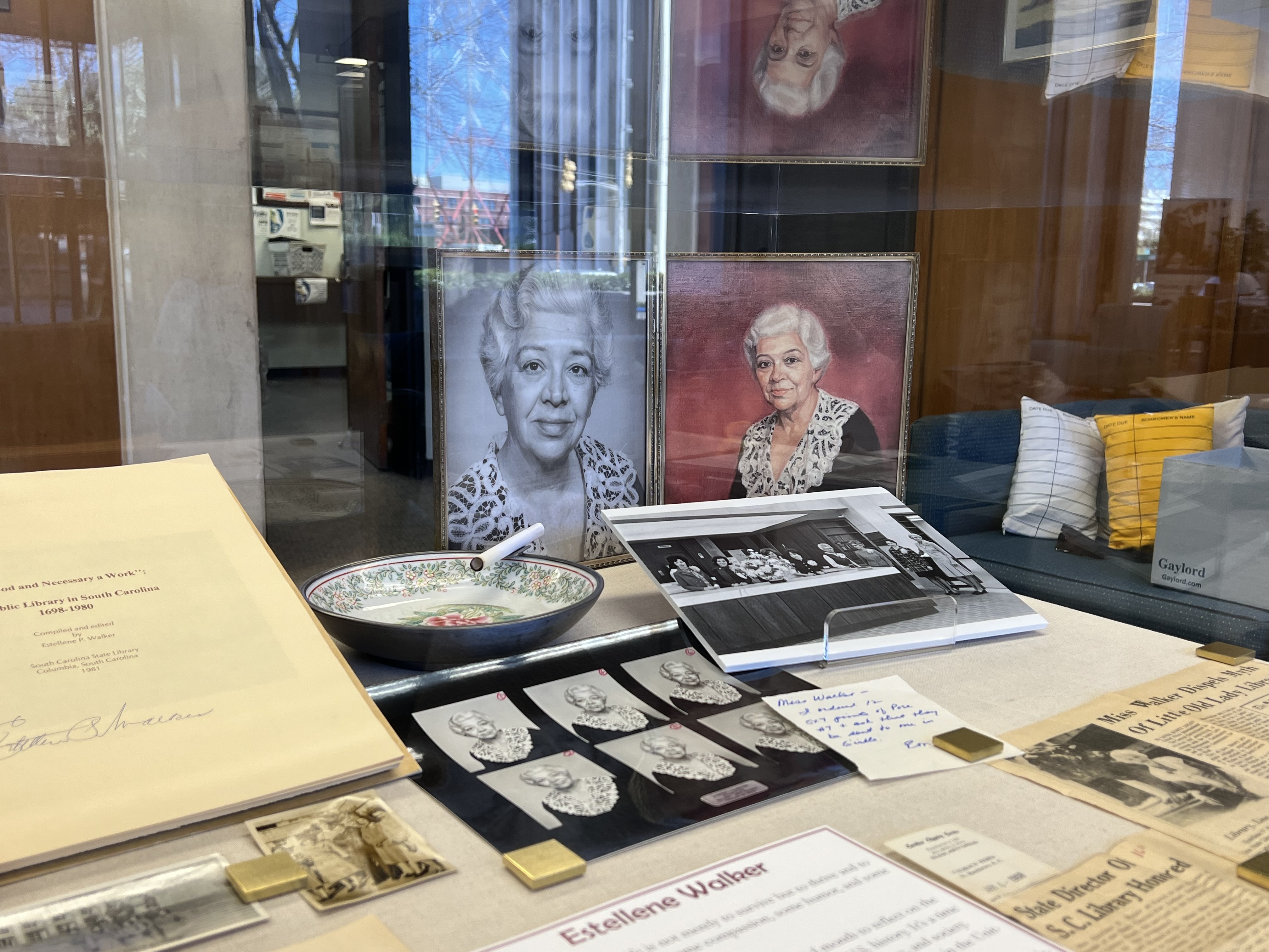 Display case featuring photos and documents from Estellene Walker