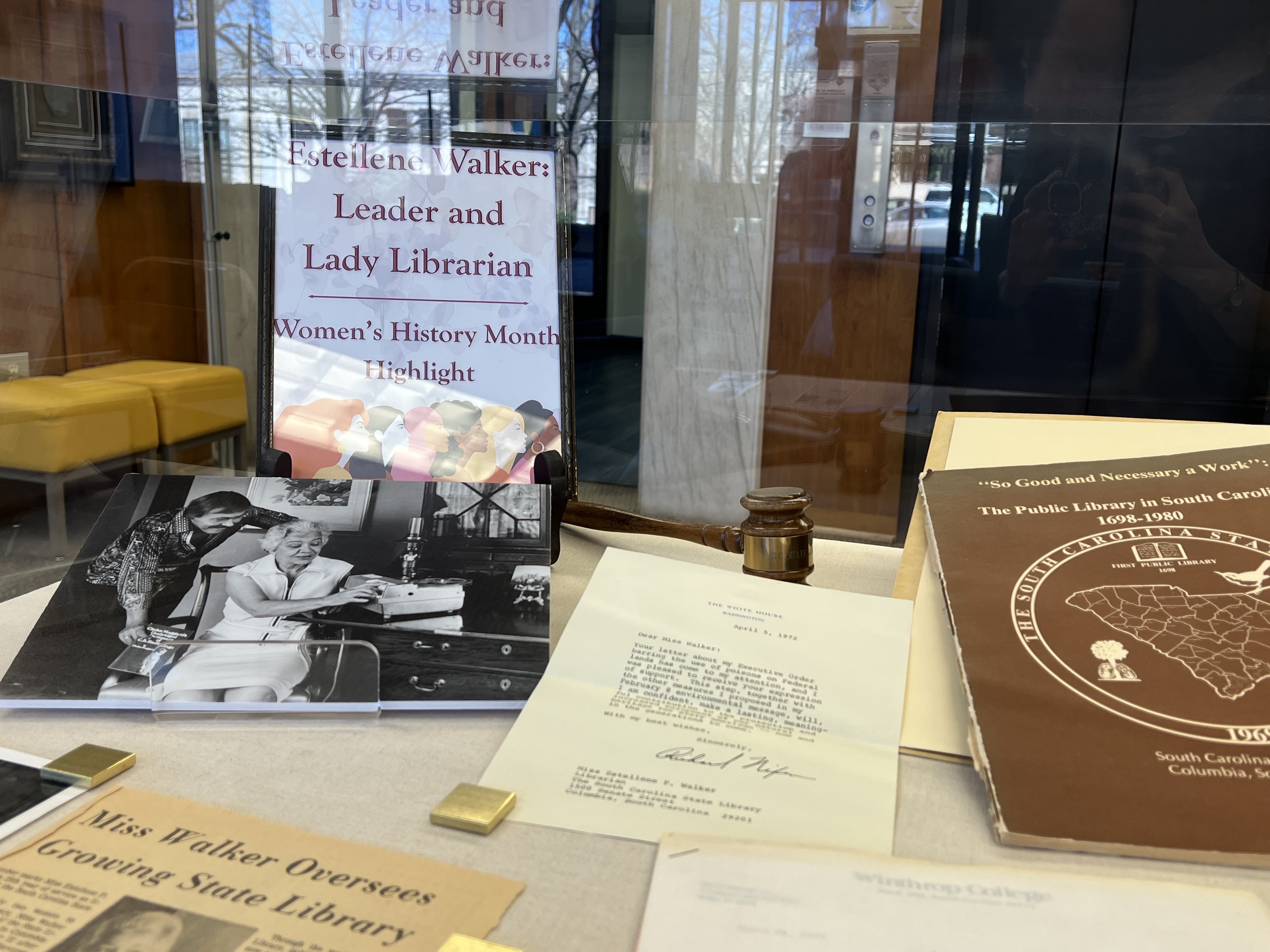 Display case featuring photos and documents from Estellene Walker