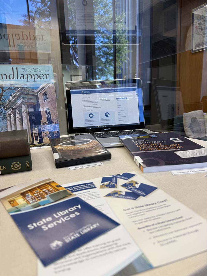More items in the display case featured library cards and brochures.