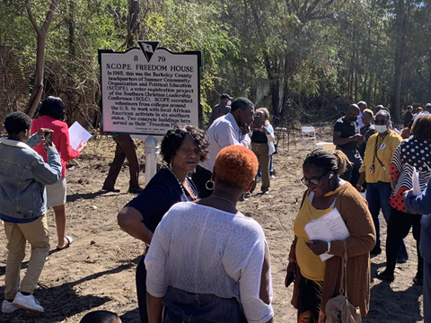 Photo of people surrounding a new historical marker.