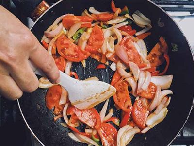 Stir fried tomatoes and onions in a iron skillet.