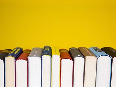 Books against a yellow background