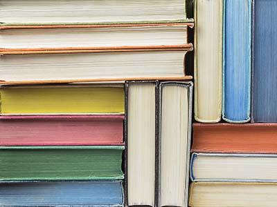 Stacked books showing their pages