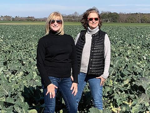 Photo of with Kugels and Collards authors Lyssa Kligman Harvey and Rachel Gordon Barnett in a field of collards